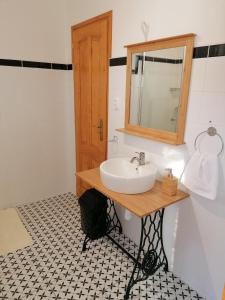 a bathroom with a sink and a mirror at István Vendégház in Mórahalom