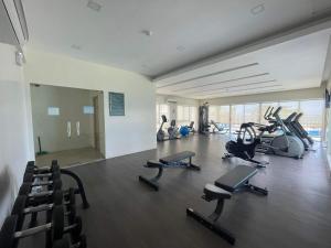 a gym with several treadmills and exercise bikes at B2B Condo, MARINA SPATIAL - Dumaguete in Dumaguete