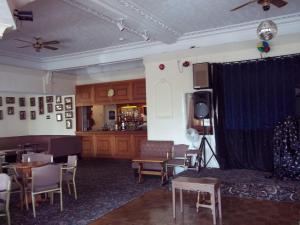 a living room with a couch and a table and chairs at Ashley Court Hotel in Torquay