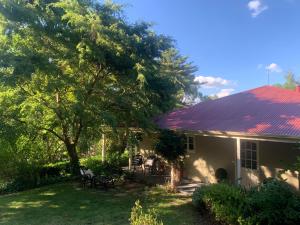 uma casa com um telhado vermelho e um quintal em Fleetwood Cottage Bed and Breakfast em Mylor