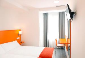Habitación de hotel con cama y ventana en San Remo, en Alicante