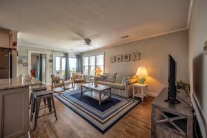 a living room with a couch and a table at Sandy's Spot 605 IC in Avon
