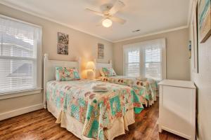 two beds in a bedroom with two windows at Sandy's Spot 605 IC in Avon +18 photos
