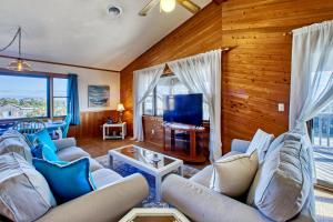 a living room with two couches and a television at 1 Good Life 774 in Avon