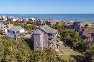 an aerial view of a neighborhood with houses and the ocean at Rogue Wave 146 in Avon