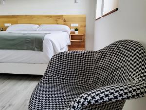 a bedroom with a bed and a couch in it at Hotel Marqués de Aguilar in Aguilar de Campóo