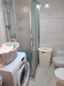 a bathroom with a washing machine and a toilet at Villetta Paola marina di Ostuni in Villanova di Ostuni