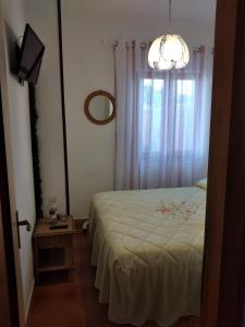 a small bedroom with a bed and a window at Villetta Paola marina di Ostuni in Villanova di Ostuni