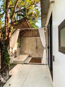 an open door to a bathroom with a bath tub at Mimi House in Hoi An