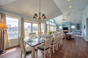 a dining room with a long table and chairs at Sea Isle Escape 193 in Waves