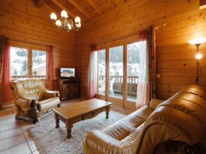 a living room with a couch and a coffee table at Appartement La Clusaz, 4 pièces, 6 personnes - FR-1-304-277 in La Clusaz