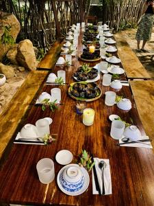 a long table with plates of food on it at Chành Rành House in Vĩnh Hy +77 photos