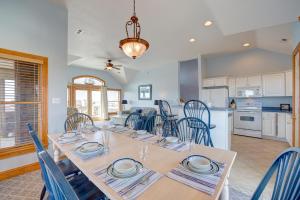 a dining room and kitchen with a table and chairs at Passing Winds 741 in Salvo