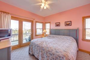a bedroom with a bed and a flat screen tv at Passing Winds 741 in Salvo
