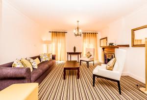 a living room with a couch and a table at Tudor Barn - Little England Cottages in Nuwara Eliya
