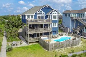 an aerial view of a blue house with a swimming pool at Castle in the Sand 453 in Avon