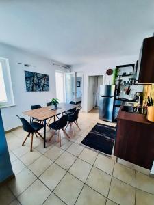 a kitchen and dining room with a table and chairs at Apartment Novalja on the moon in Novalja