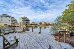 a dock with a bench and houses on the water at Horizon House 405 in Frisco