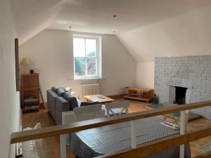 a living room with a couch and a fireplace at Fabulous loft, great views in Buxton