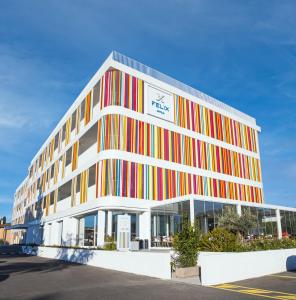 un edificio de oficinas con rayas de colores. en Felix Hotel Olbia, en Olbia