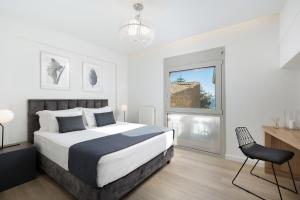 um quarto com uma cama, uma cadeira e uma janela em A Luxury Retreat in Corfu Town by Konnect em Corfu Town