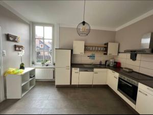cocina con electrodomésticos blancos y ventana grande en Ferienwohnung Leonie, en Goslar 8 fotos más