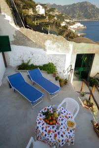 - une table et des chaises sur une terrasse avec vue sur l'eau dans l'établissement Da Rita, à Amalfi