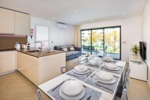 une cuisine et une salle à manger avec une table et des chaises dans l'établissement Apartamento Porlamar, à Quarteira