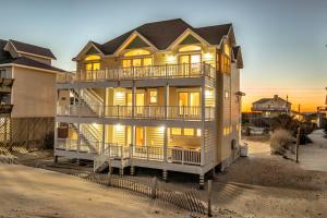 a large house with balconies on a beach at Coastal Charm 220 in Avon