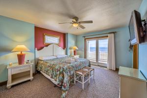 a bedroom with a bed and a view of the ocean at Coastal Charm 220 in Avon
