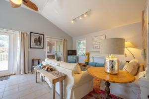 a living room with a couch and a table at 4 Salty Paws 147 in Avon