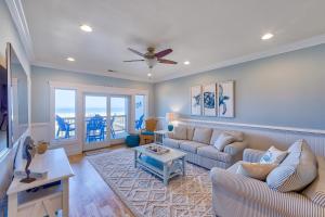a living room with a couch and a table at Seas the Day 991 RR in Rodanthe