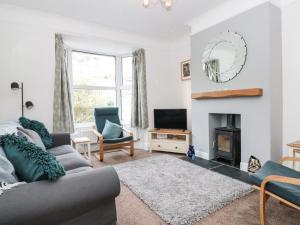 a living room with a couch and a fireplace at Hillside in Dartmouth