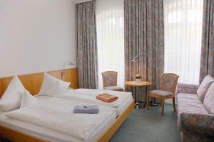 Ein Bett oder Betten in einem Zimmer der Unterkunft Akzent Hotel Delitzsch