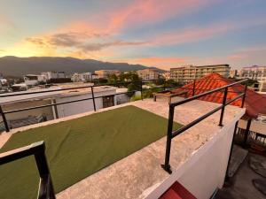 a balcony with a green lawn on top of a building at Bake Room Hostel in Chiang Mai