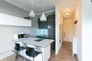 a kitchen with a white counter and some black cabinets at Residence Vera Cruz in Lido di Jesolo