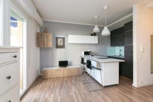 a kitchen with white cabinets and a counter top at Residence Vera Cruz in Lido di Jesolo