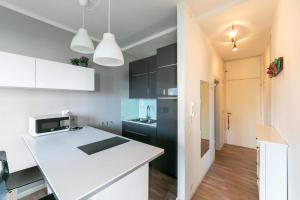 a kitchen with white cabinets and a white counter top at Residence Vera Cruz in Lido di Jesolo +109 photos