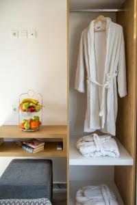 two pictures of a towel in a closet at Deluxe City Hotel in Chania