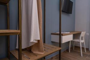 a room with a mirror and a table with a chair at Vagabond Guesthouse in Athens