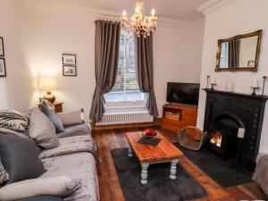 a living room with a couch and a fireplace at Charlotte House in Whitby