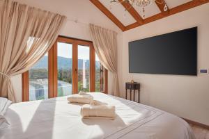 a bedroom with a bed with towels on it at Villa Lovorno in Arbanasi +22 photos