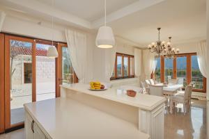 a kitchen and dining room with a table and chairs at Villa Lovorno in Arbanasi