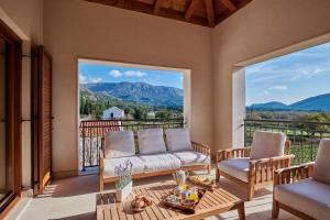 a living room with a couch and chairs on a balcony at Villa Lovorno in Arbanasi