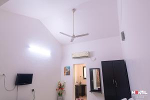 a white room with a ceiling fan and a mirror at Henmil Anjuna in Anjuna