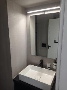 a bathroom with a white sink and a mirror at NY Central 2 in Patra