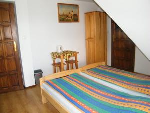 a bedroom with a bed and a small table at U Poraja in Ząb