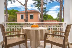 a table with a bowl of oranges on a balcony at Pyrgaraki Studios and Apartments in Vasilikos