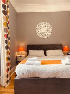 a bedroom with a large bed and two lamps at The Westbank in Torquay