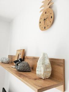 a wooden shelf with a clock on a wall at Obzor Tatyana Apartaments Natura in Obzor